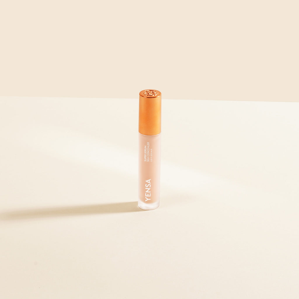 YENSA Super Serum Silk Concealer tube with soft-focus under-eye swatch on medium skin tone