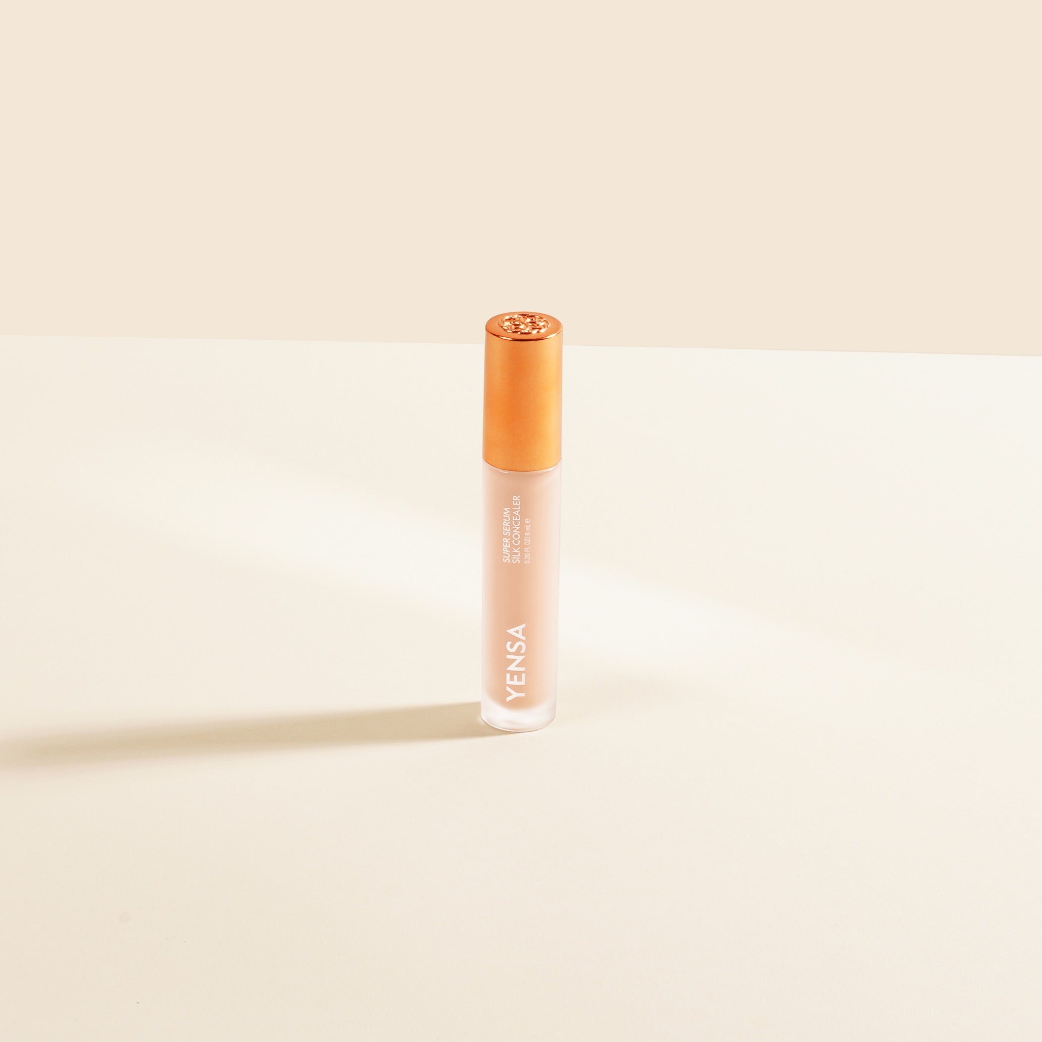 YENSA Super Serum Silk Concealer tube with soft-focus under-eye swatch on medium skin tone