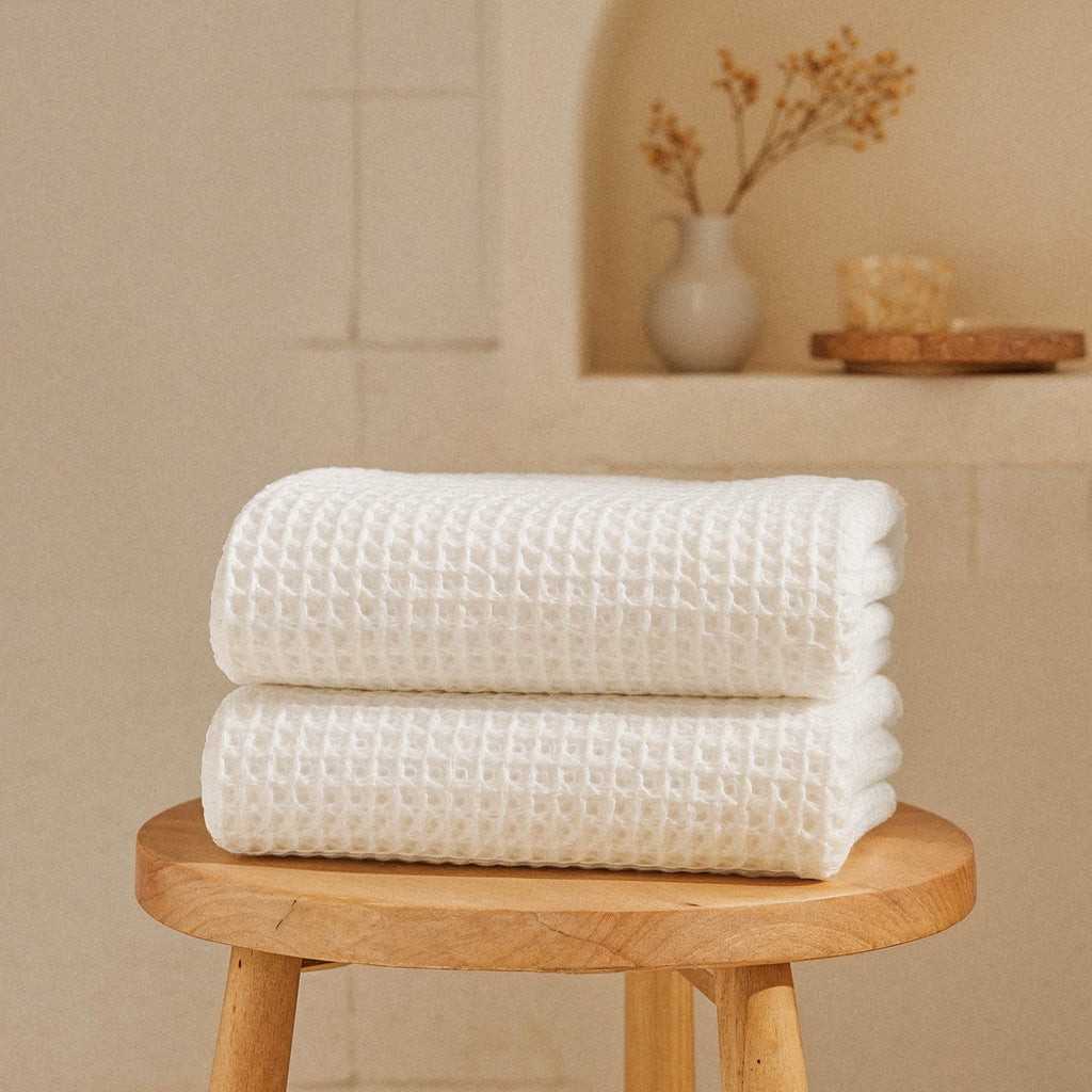 Folded Sedona Australian cotton waffle towels in a neutral colorway, showing dimensional open-weave texture