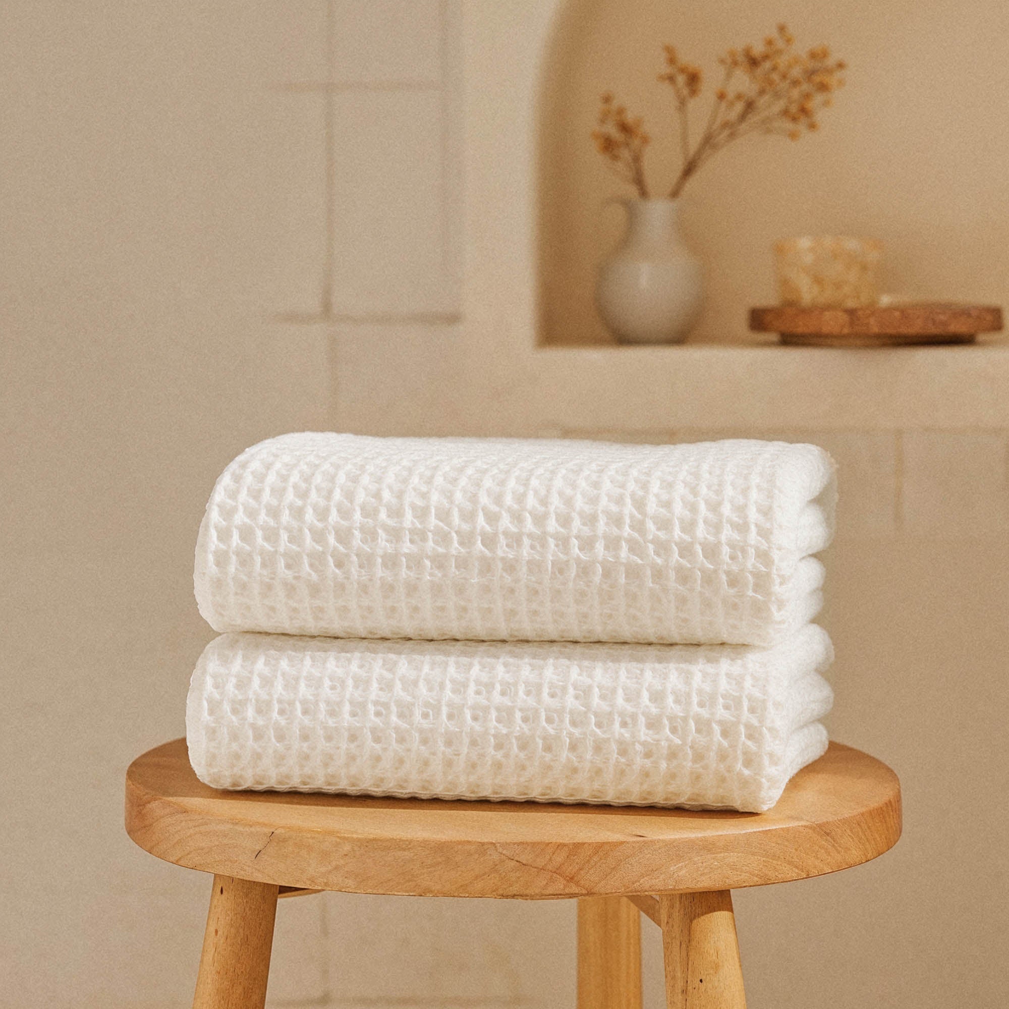 Folded Sedona Australian cotton waffle towels in a neutral colorway, showing dimensional open-weave texture