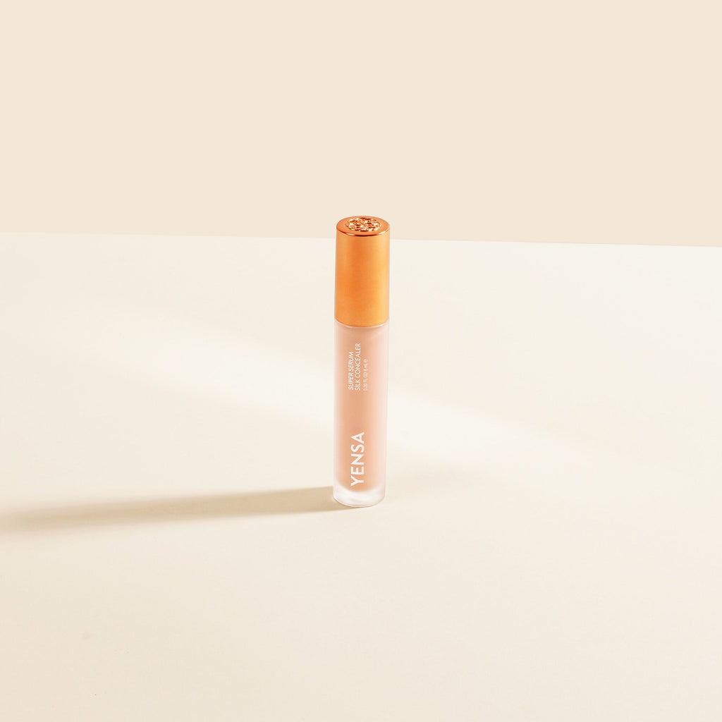 YENSA Super Serum Silk Concealer tube with soft-focus under-eye swatch on medium skin tone