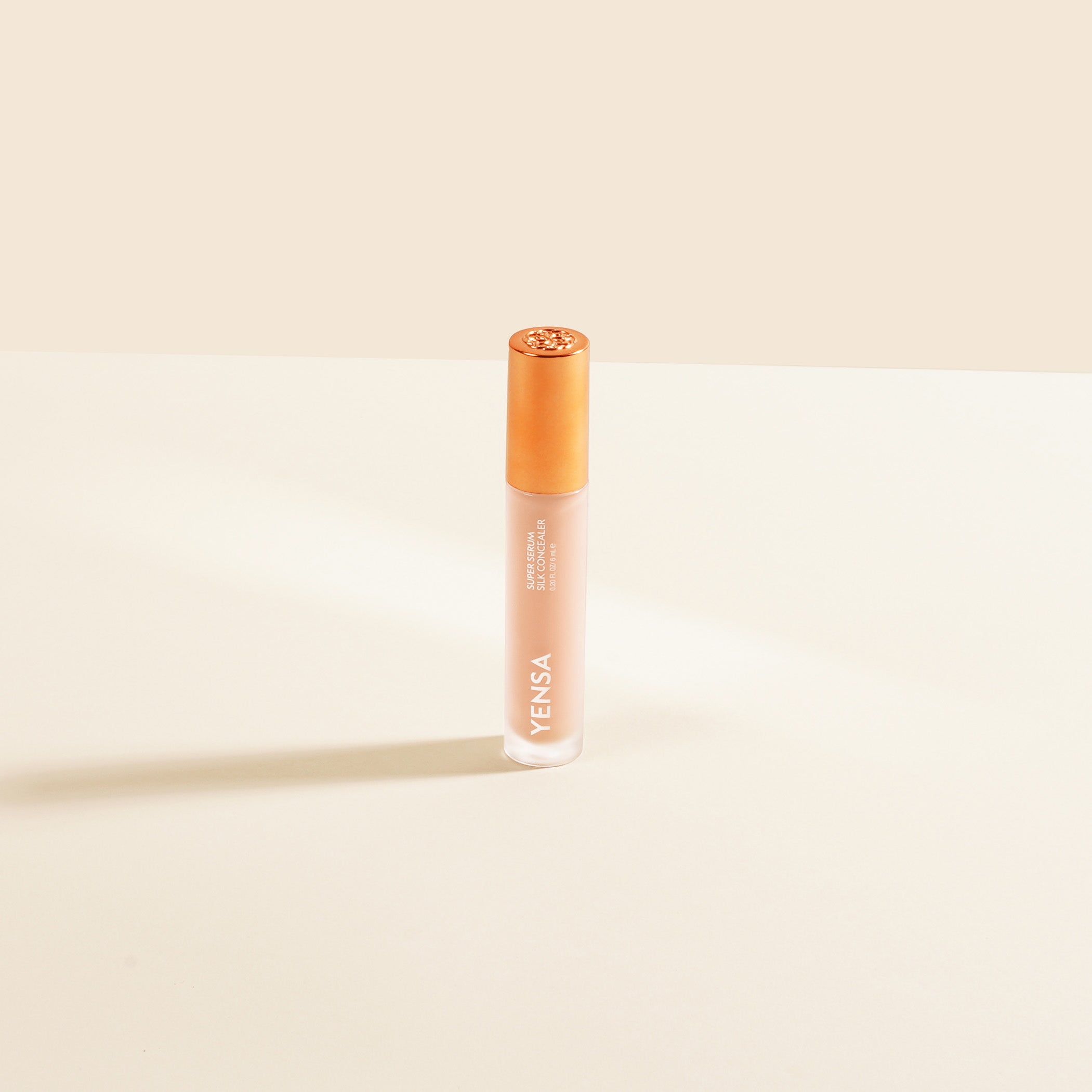 YENSA Super Serum Silk Concealer tube with soft-focus under-eye swatch on medium skin tone