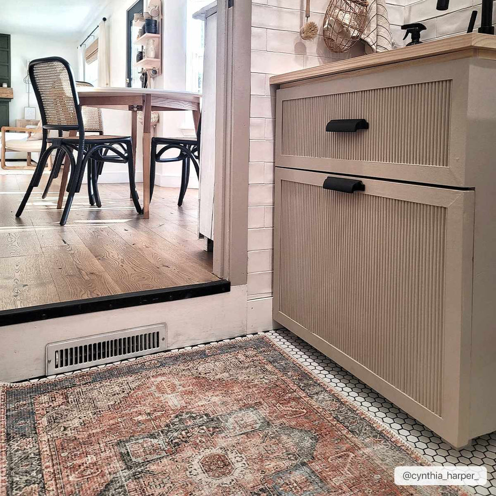 Rosman distressed flat weave area rug in warm red, blue, and earthy tones with vintage-inspired pattern