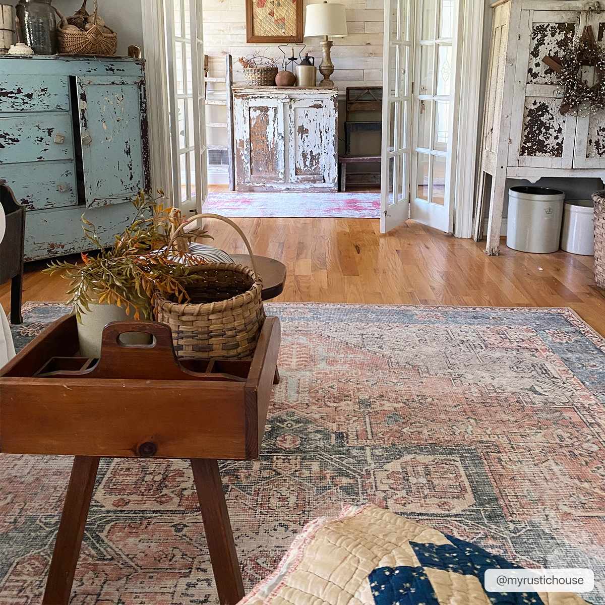 Rosman distressed flat weave area rug in warm red, blue, and earthy tones with vintage-inspired pattern
