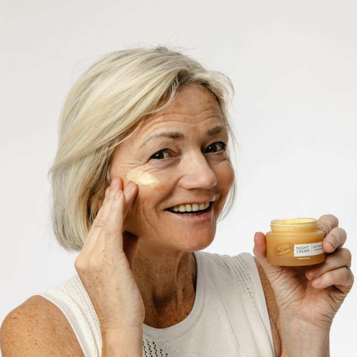 UpCircle Night Cream in glass jar with aluminum lid, showing hyaluronic acid and niacinamide overnight moisturizer