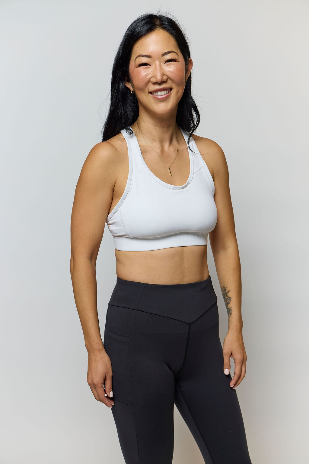 Front view of the 99'er padded sports bra in a solid colorway showing the crossover hexagonal back detail and sleek silhouette