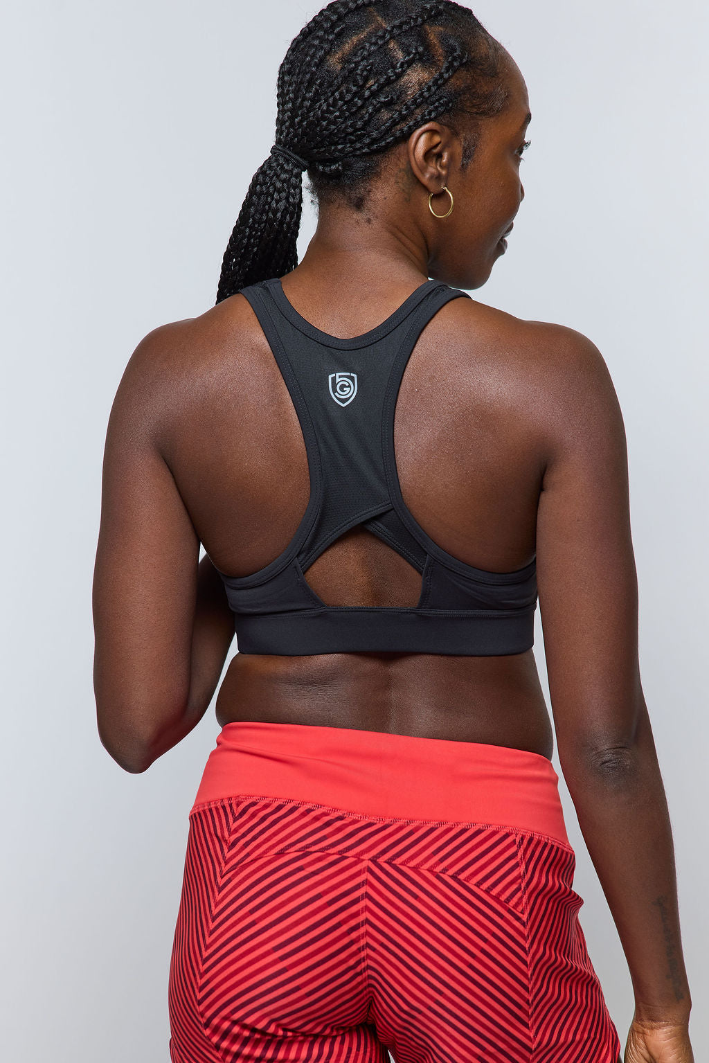 Women's Excel workout shorts in a relaxed training fit, showing extended hem length and waistband pocket detail