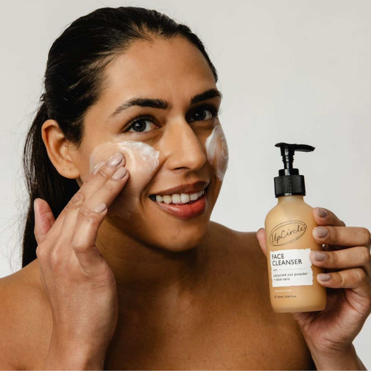 UpCircle Cleansing Face Milk bottle with upcycled oat powder and aloe vera formula on a clean white surface