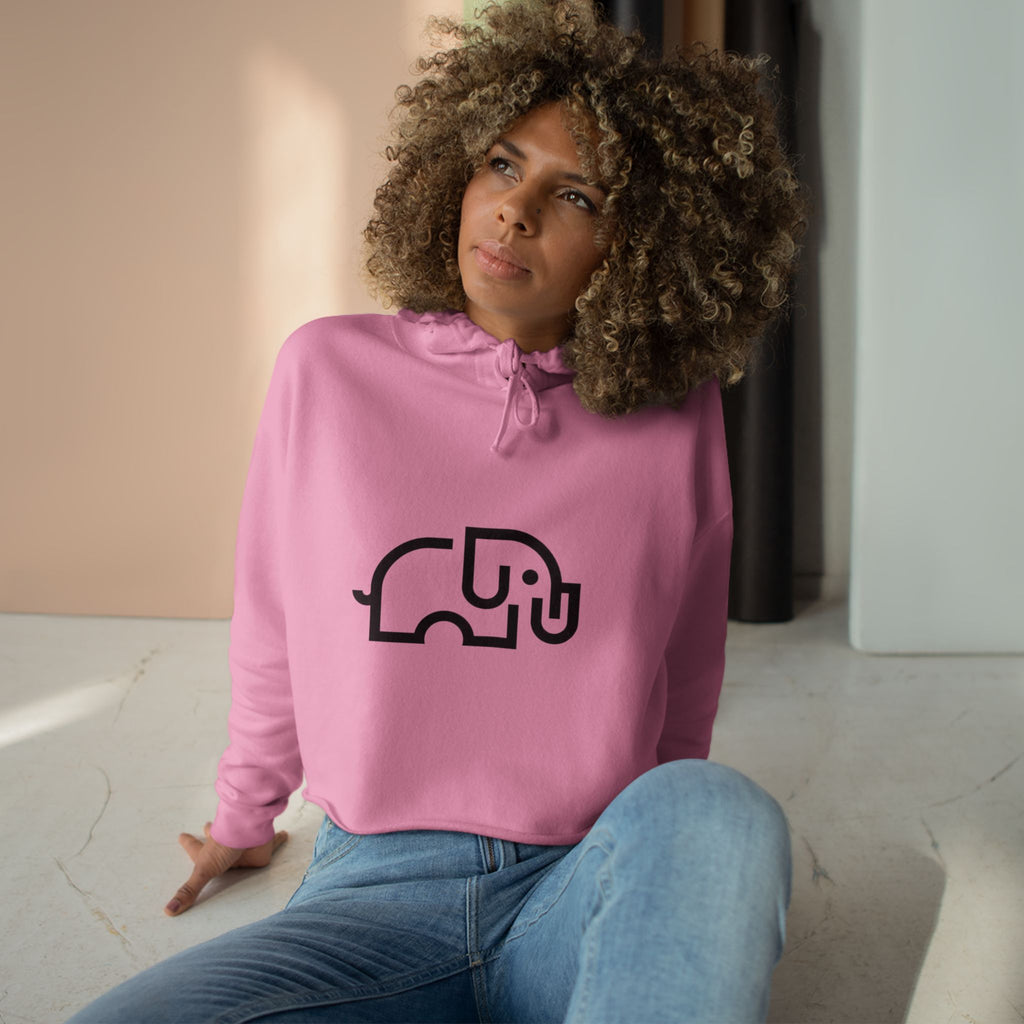 Women's pale pink cropped hoodie with minimalist single-line elephant graphic on chest, shown from front on female model
