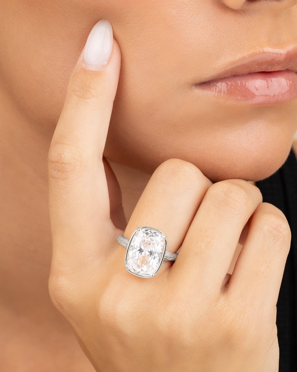Elongated cushion-cut cubic zirconia cocktail ring in gold-plated sterling silver on a hand, showing large faceted stone and slim band