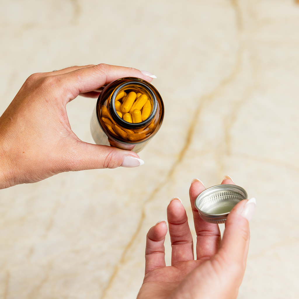 Daily probiotic starter kit in a reusable glass jar with white capsules and minimal packaging