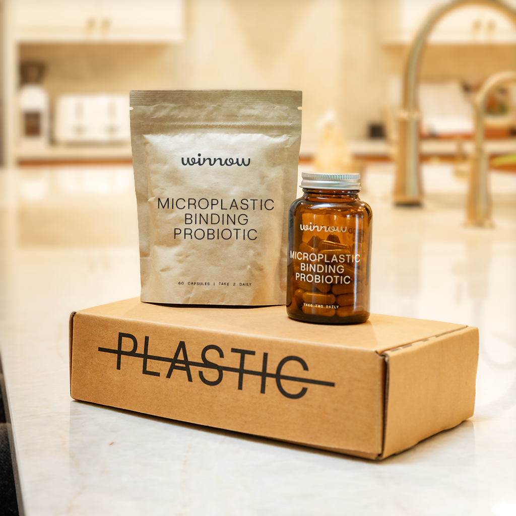Daily probiotic starter kit in a reusable glass jar with white capsules and minimal packaging