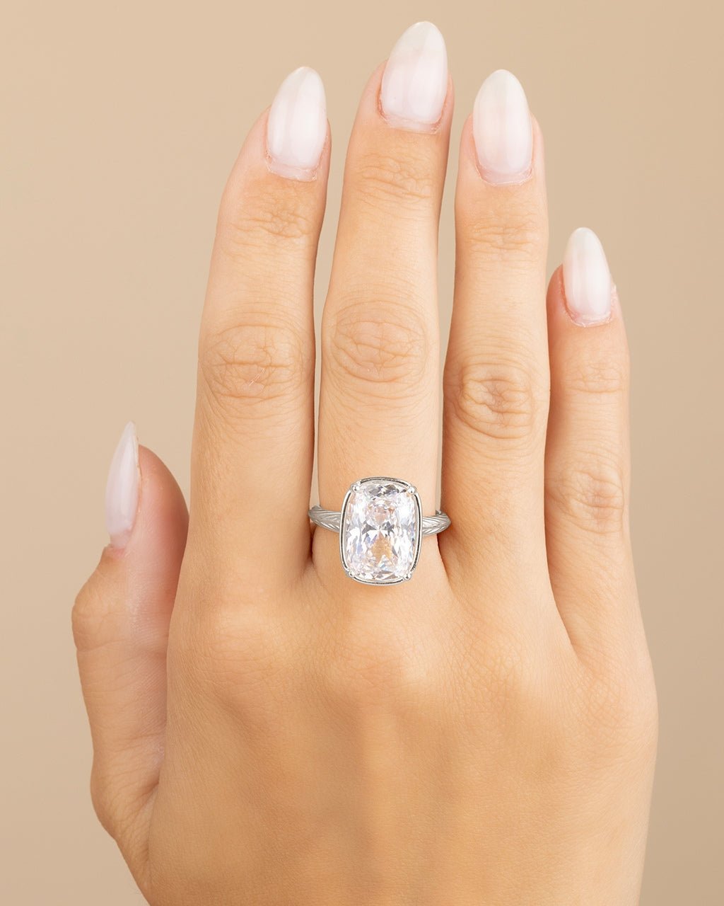 Elongated cushion-cut cubic zirconia cocktail ring in gold-plated sterling silver on a hand, showing large faceted stone and slim band