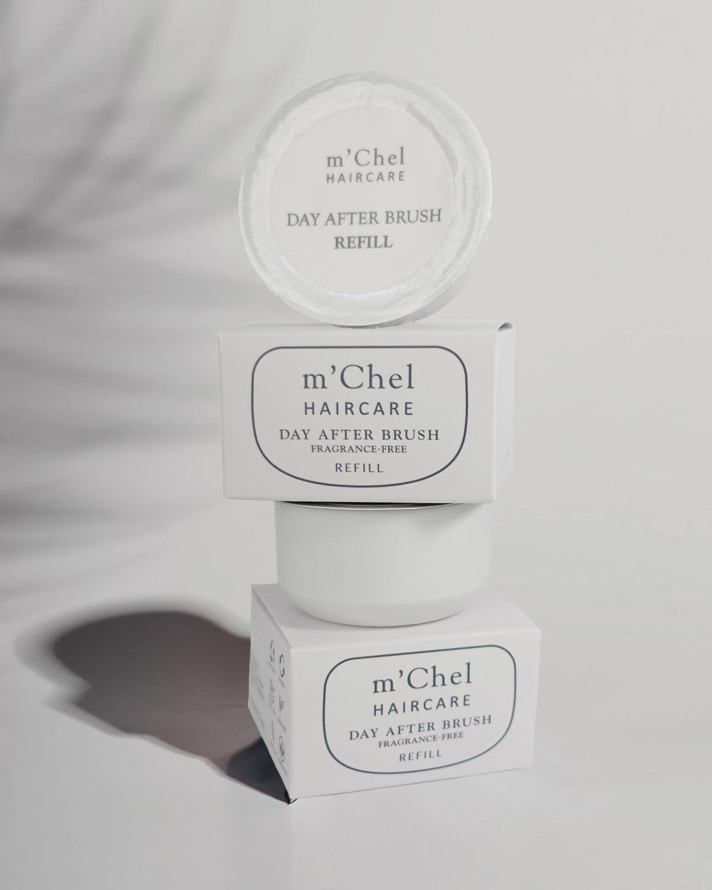 Day After dry shampoo brush refill powder canister in neutral packaging against a clean white background