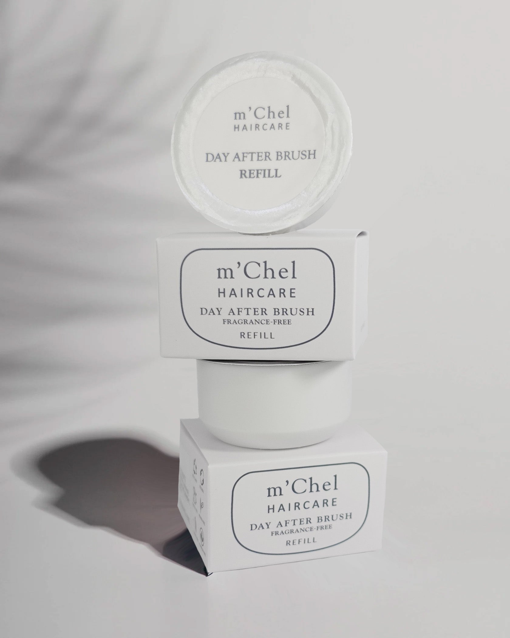 Day After dry shampoo brush refill powder canister in neutral packaging against a clean white background