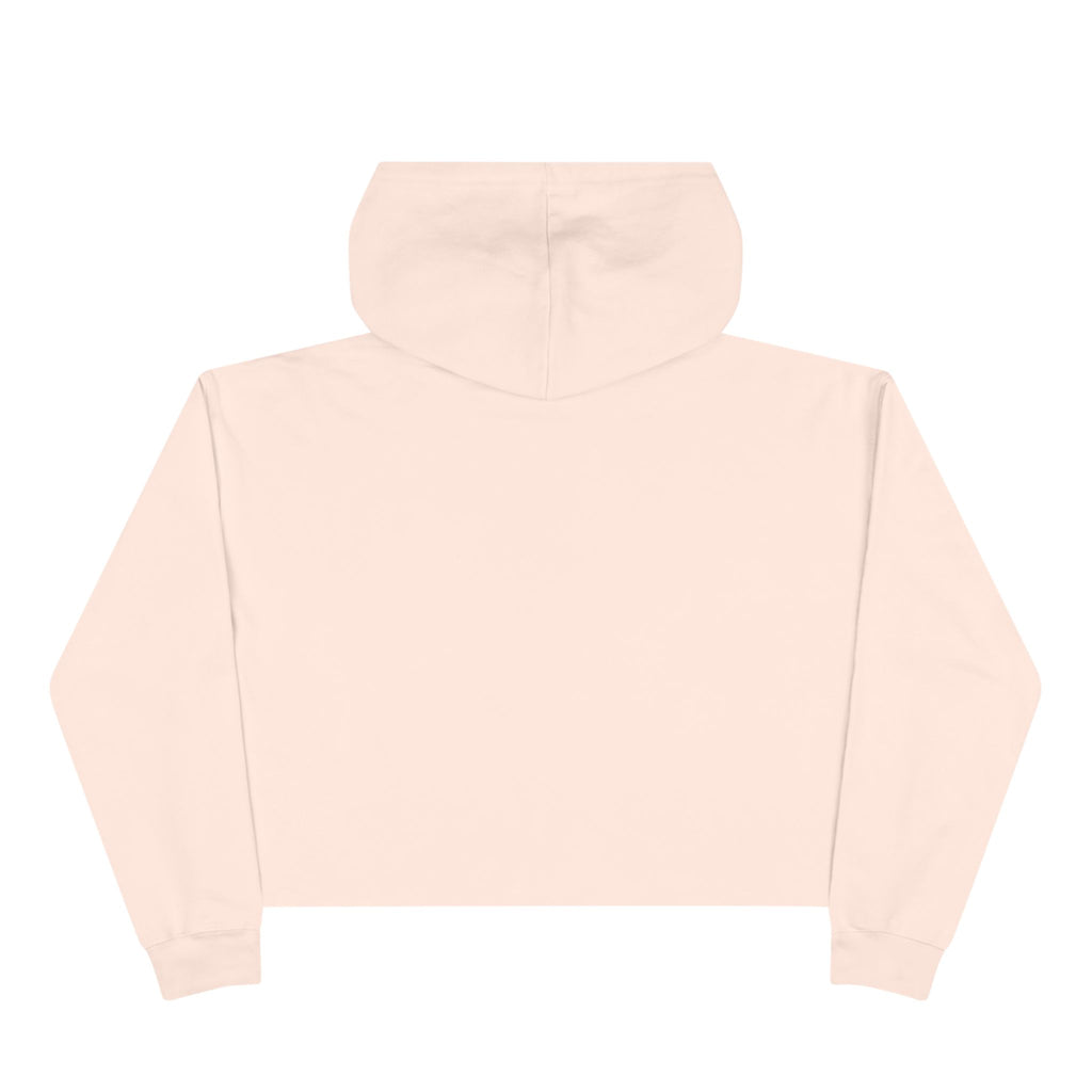 Women's pale pink cropped hoodie with minimalist single-line elephant graphic on chest, shown from front on female model