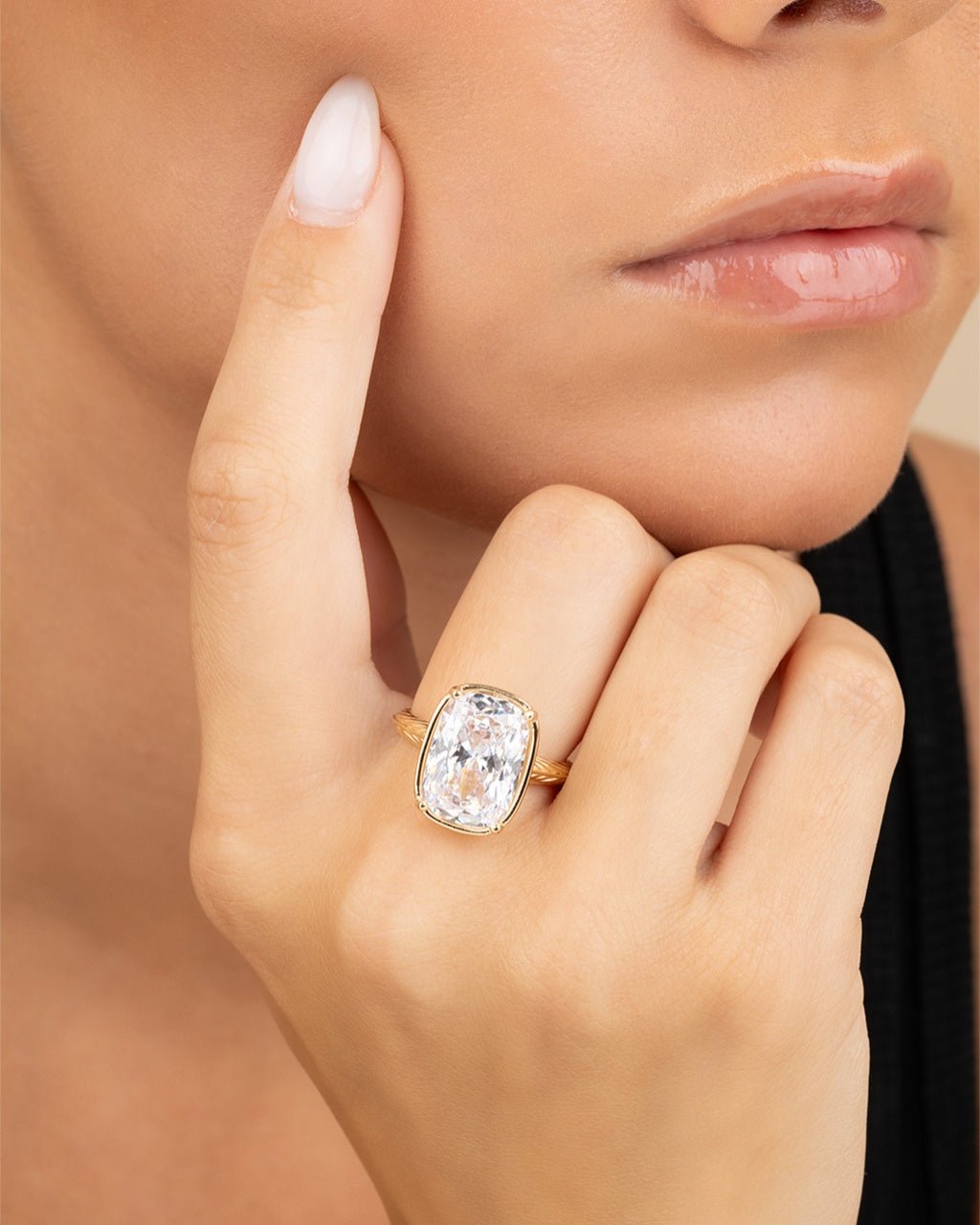 Elongated cushion-cut cubic zirconia cocktail ring in gold-plated sterling silver on a hand, showing large faceted stone and slim band