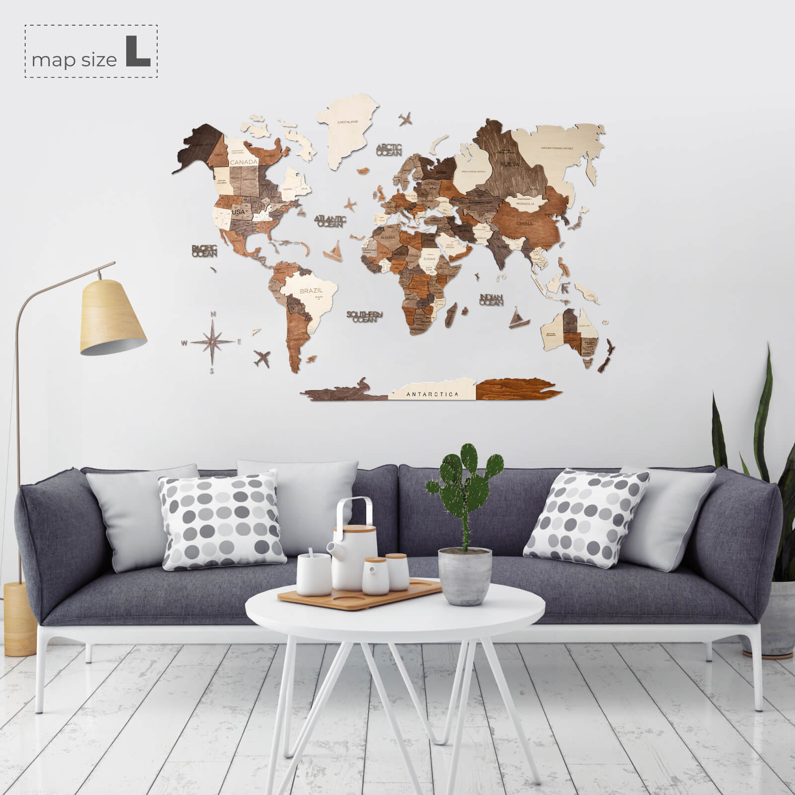 Multicolor 3D layered wooden world map wall art with engraved country names and borders mounted on a neutral wall