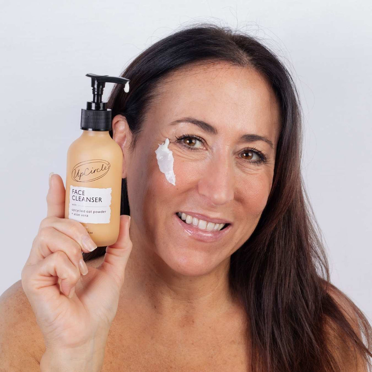 UpCircle Cleansing Face Milk bottle with upcycled oat powder and aloe vera formula on a clean white surface