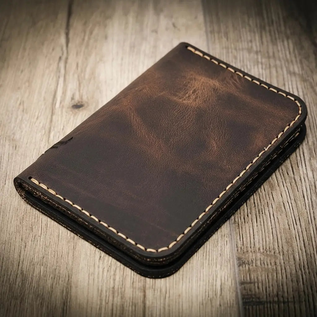 Tyler vertical wallet in full-grain tan vegetable-tanned leather, standing upright showing card slots and slim profile