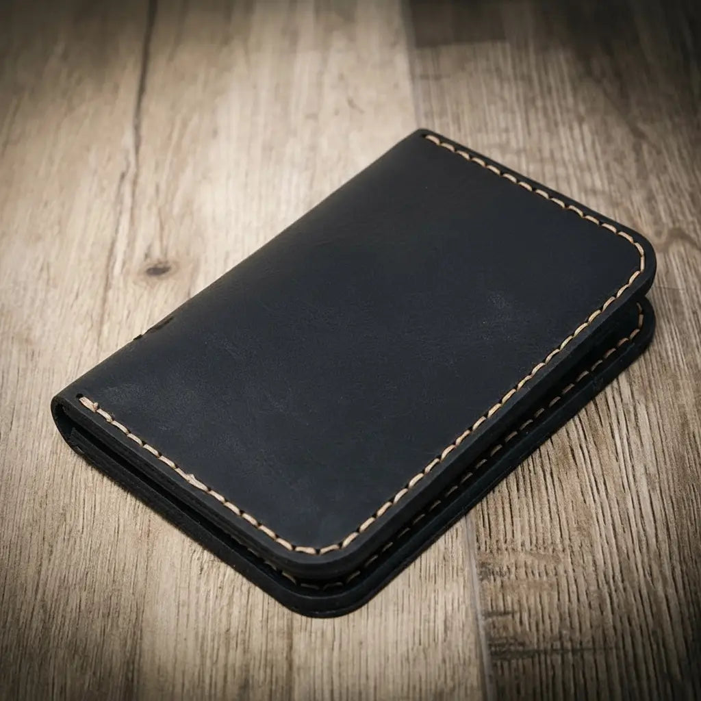 Tyler vertical wallet in full-grain tan vegetable-tanned leather, standing upright showing card slots and slim profile