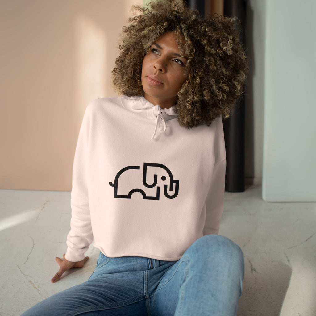 Women's pale pink cropped hoodie with minimalist single-line elephant graphic on chest, shown from front on female model