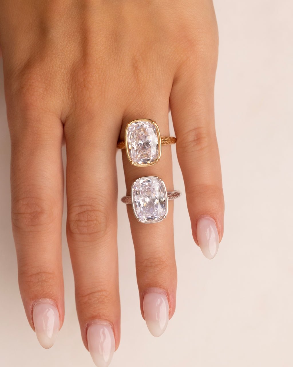 Elongated cushion-cut cubic zirconia cocktail ring in gold-plated sterling silver on a hand, showing large faceted stone and slim band