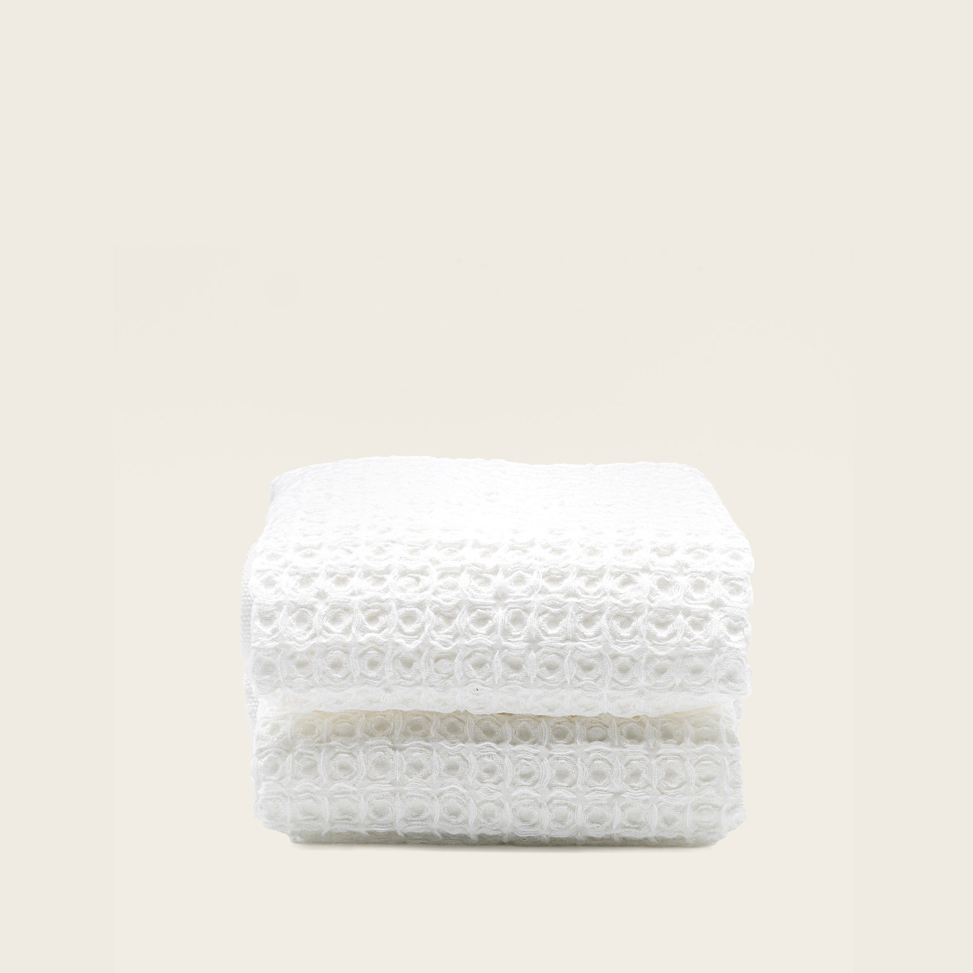 Folded Sedona Australian cotton waffle towels in a neutral colorway, showing dimensional open-weave texture