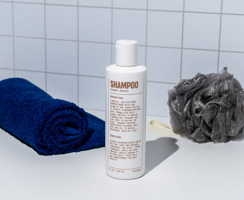 Bottle of natural daily shampoo with saw palmetto and vegan biotin on a clean surface