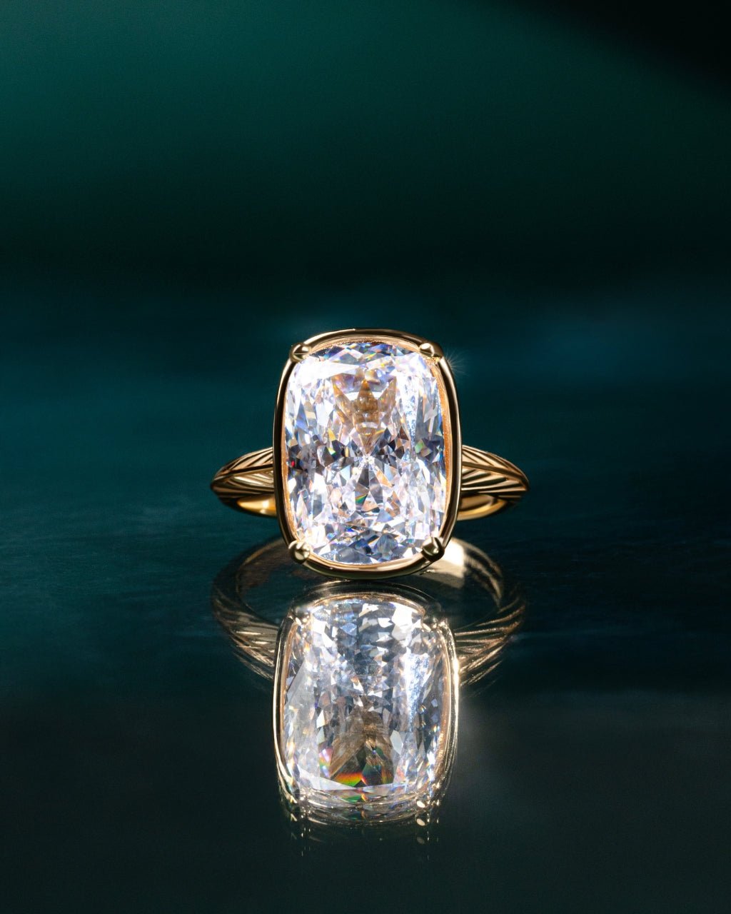 Elongated cushion-cut cubic zirconia cocktail ring in gold-plated sterling silver on a hand, showing large faceted stone and slim band
