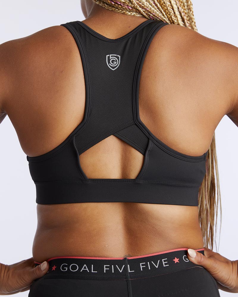 Front view of the 99'er padded sports bra in a solid colorway showing the crossover hexagonal back detail and sleek silhouette
