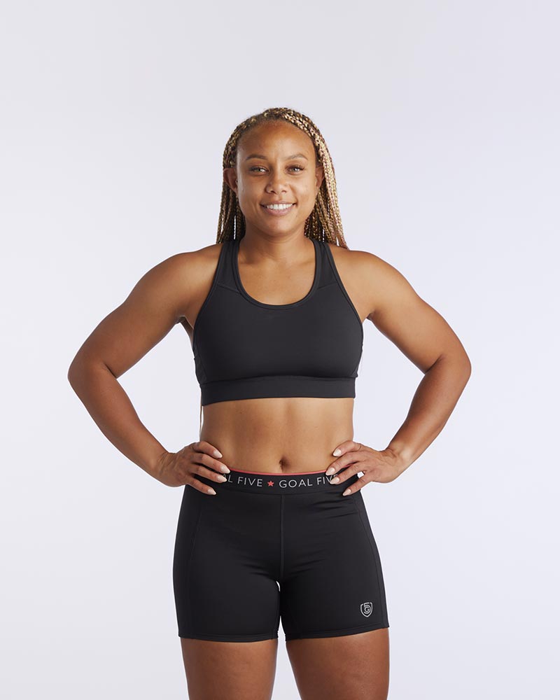Front view of the 99'er padded sports bra in a solid colorway showing the crossover hexagonal back detail and sleek silhouette