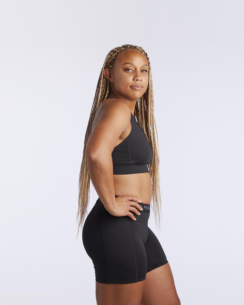 Front view of the 99'er padded sports bra in a solid colorway showing the crossover hexagonal back detail and sleek silhouette