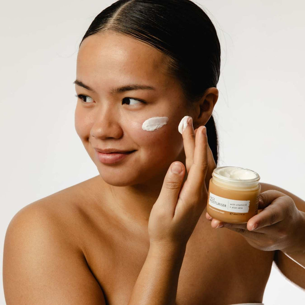 UpCircle Vitamin E Face Moisturizer in a glass jar with aluminum lid on a clean neutral background