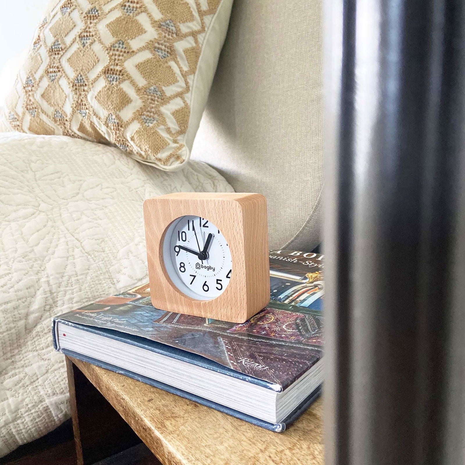 Bagby Classic solid wood analog alarm clock with numbered dial and night light on a nightstand