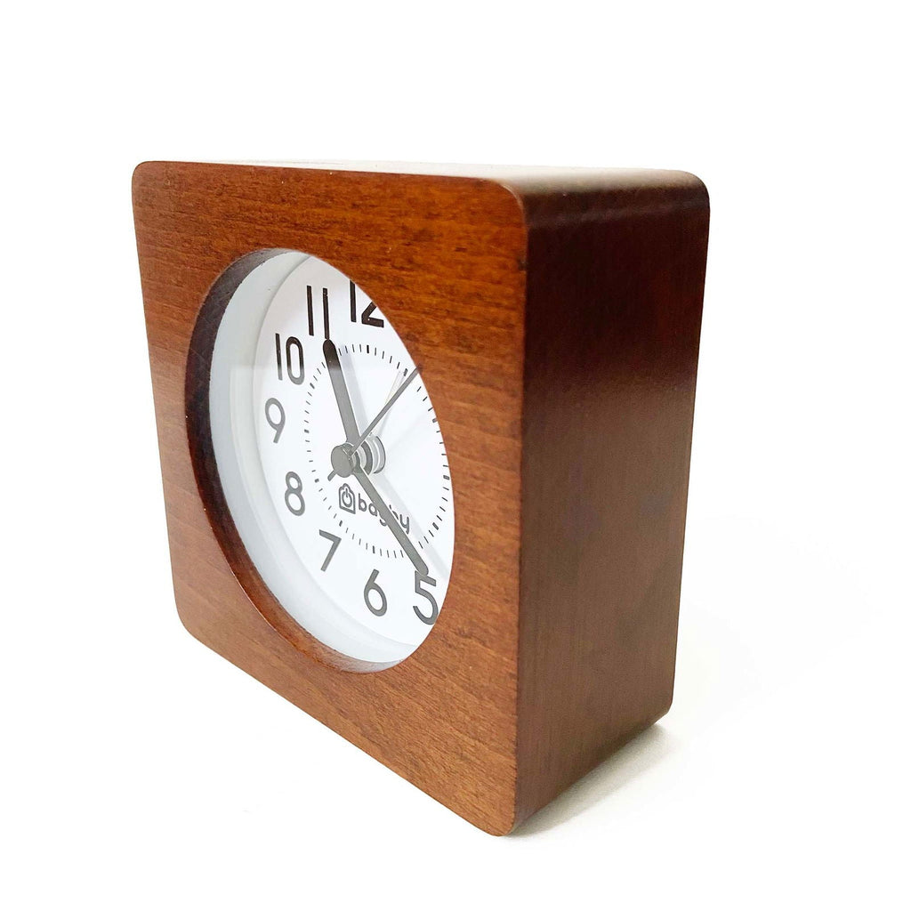 Bagby Classic solid wood analog alarm clock with numbered dial and night light on a nightstand