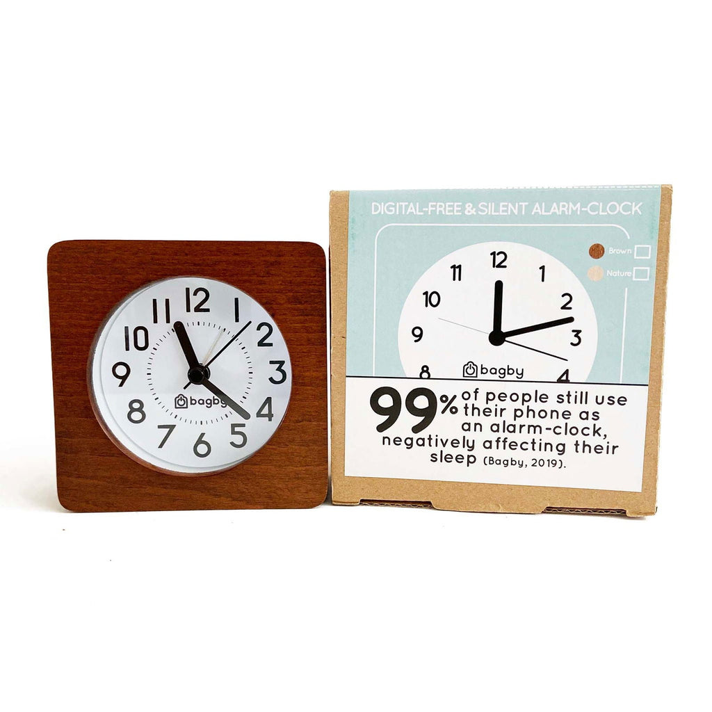 Bagby Classic solid wood analog alarm clock with numbered dial and night light on a nightstand