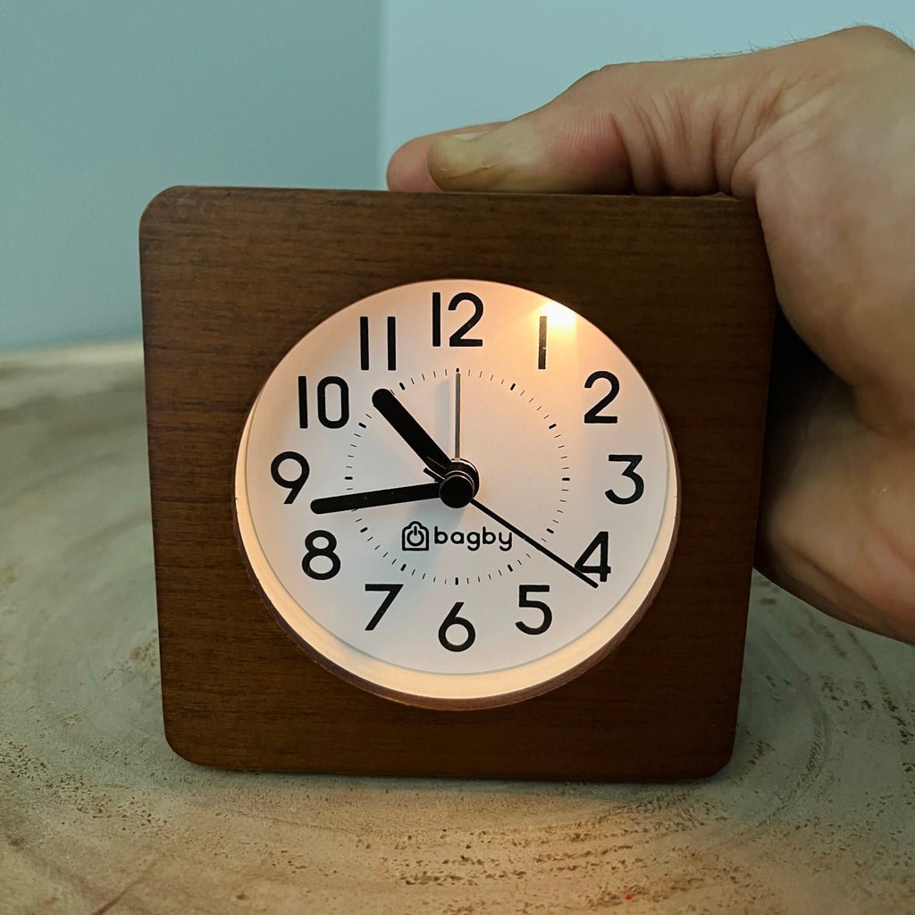 Bagby Classic solid wood analog alarm clock with numbered dial and night light on a nightstand