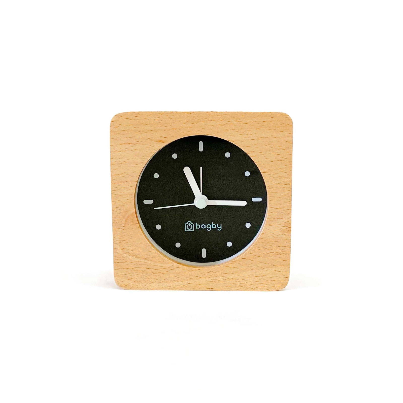 Bagby Minimalist analog alarm clock with solid wood frame and number-free dial on a nightstand