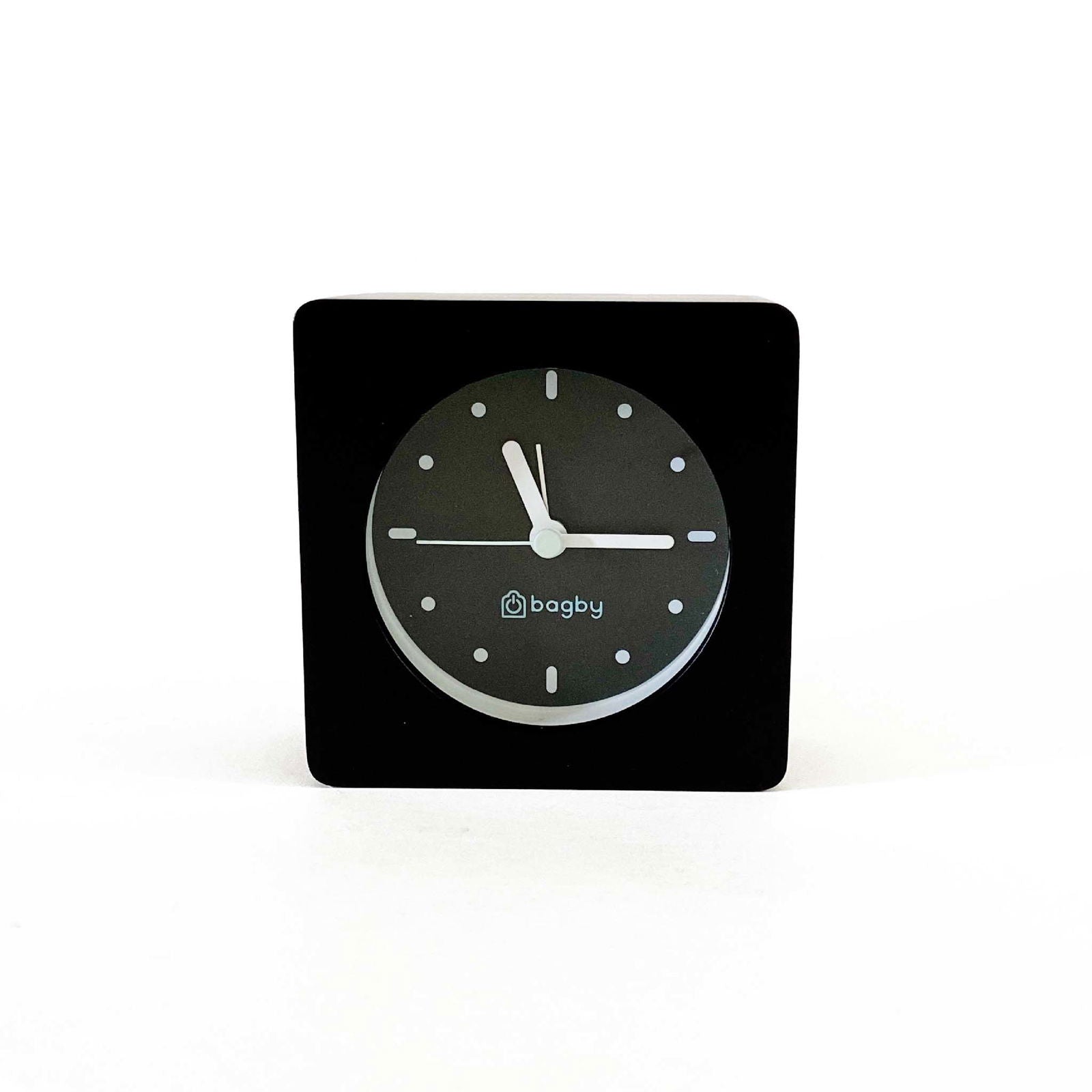 Bagby Minimalist analog alarm clock with solid wood frame and number-free dial on a nightstand