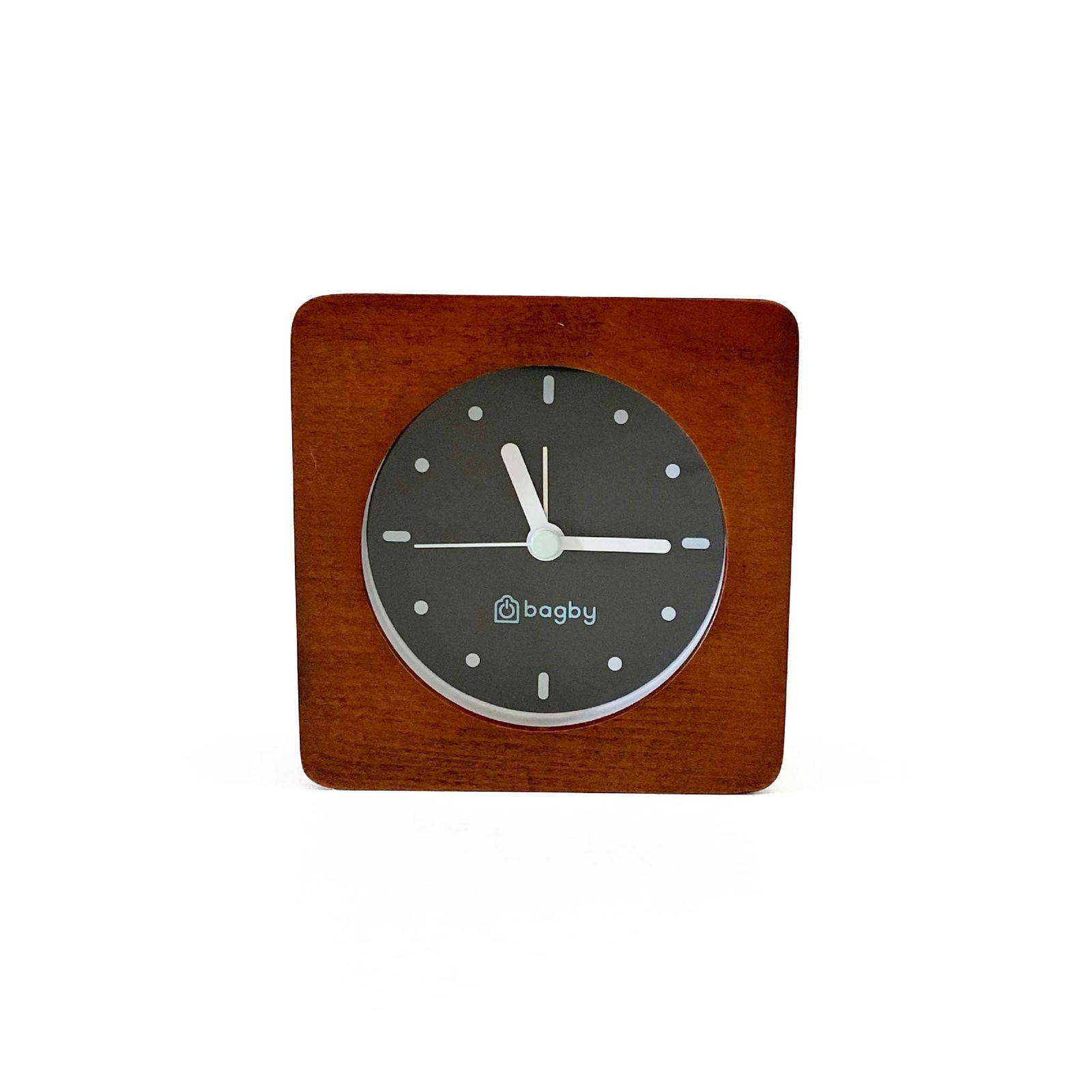 Bagby Minimalist analog alarm clock with solid wood frame and number-free dial on a nightstand