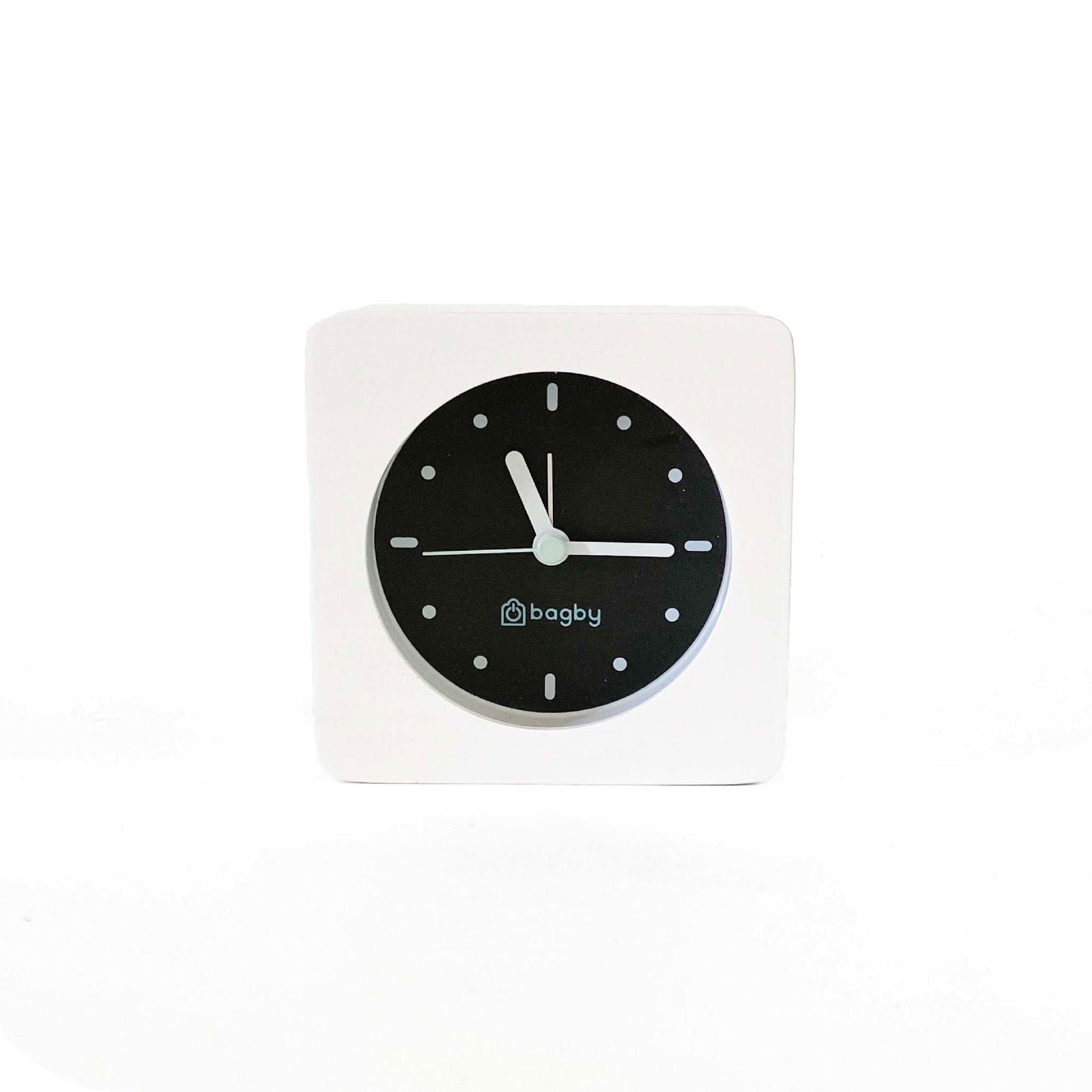 Bagby Minimalist analog alarm clock with solid wood frame and number-free dial on a nightstand