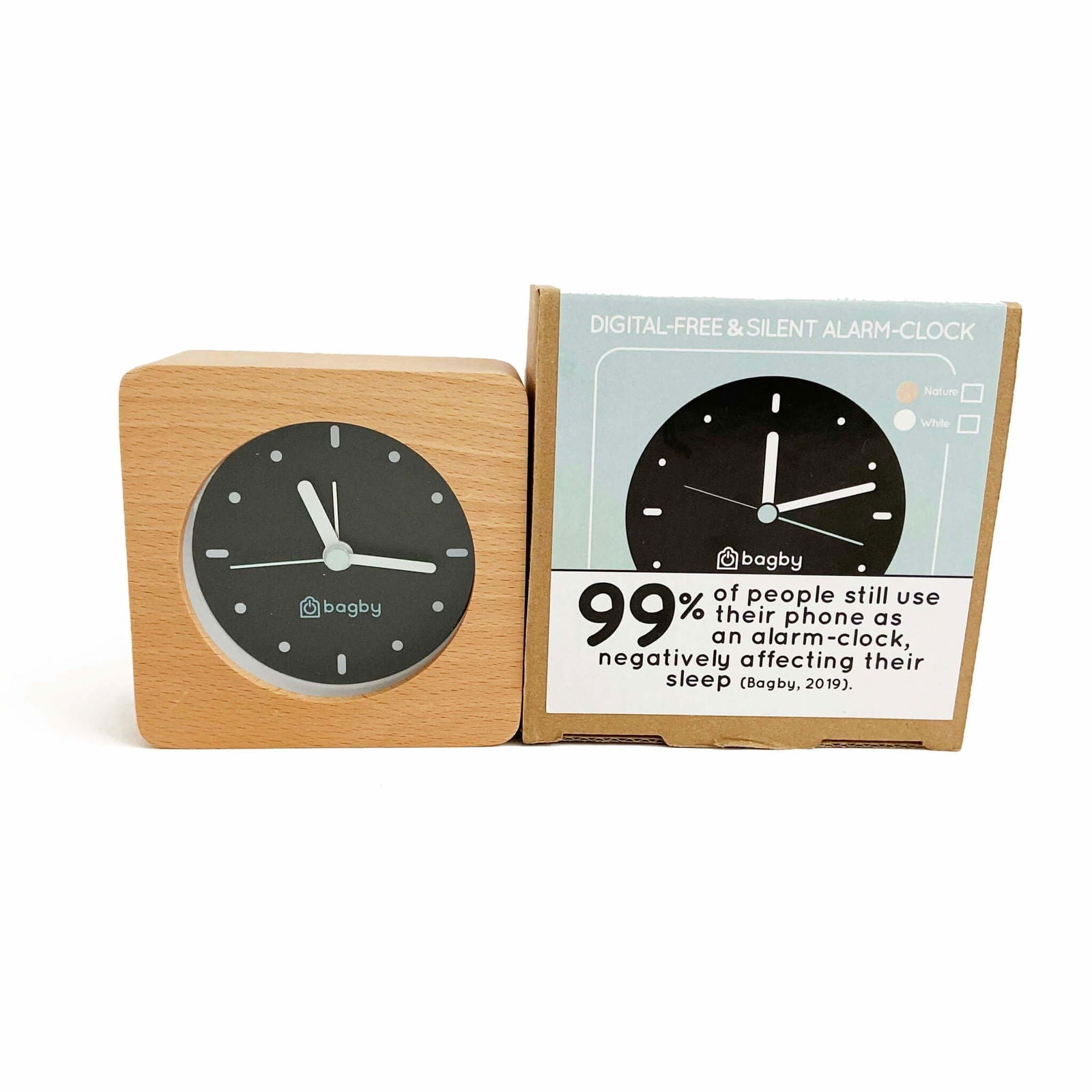 Bagby Minimalist analog alarm clock with solid wood frame and number-free dial on a nightstand