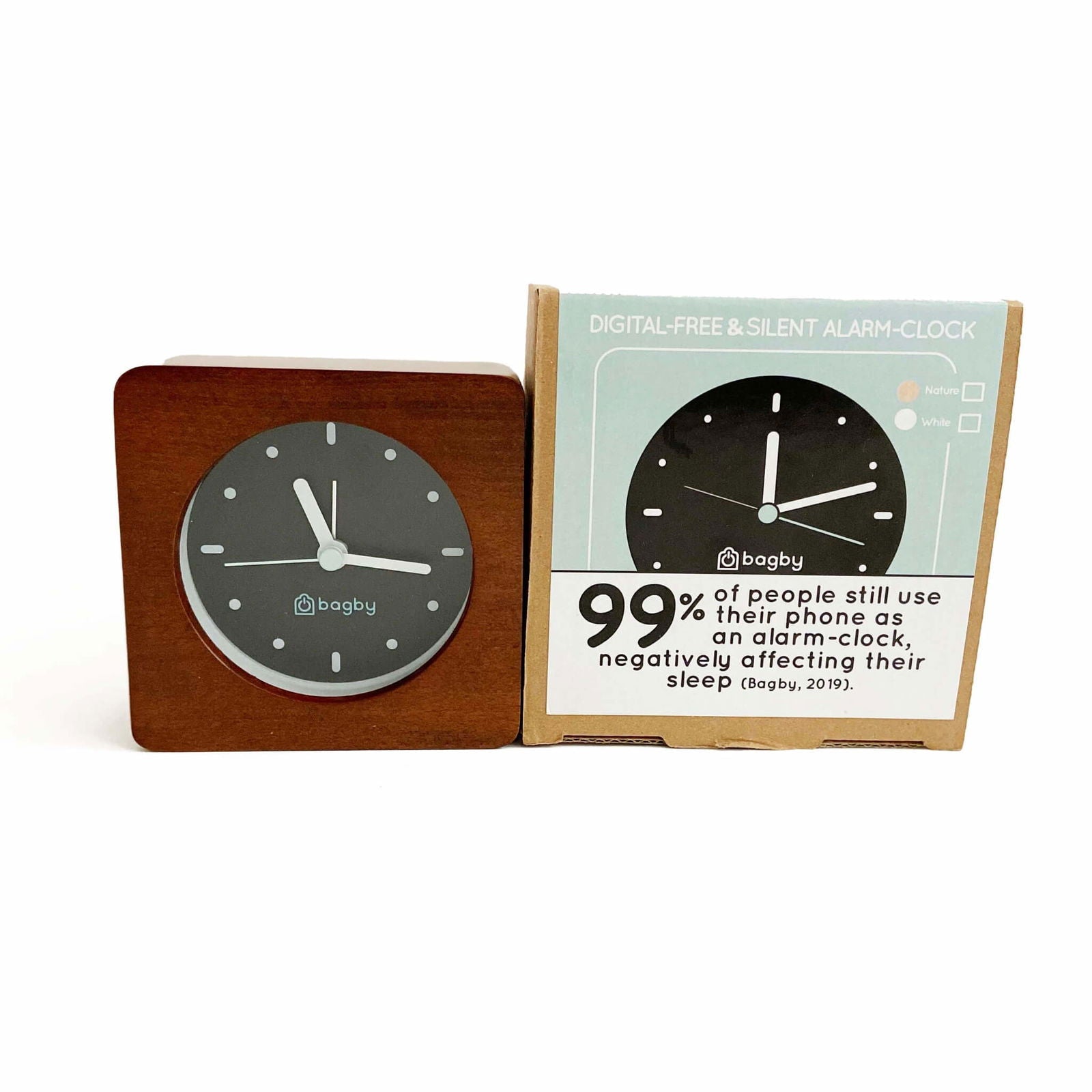 Bagby Minimalist analog alarm clock with solid wood frame and number-free dial on a nightstand