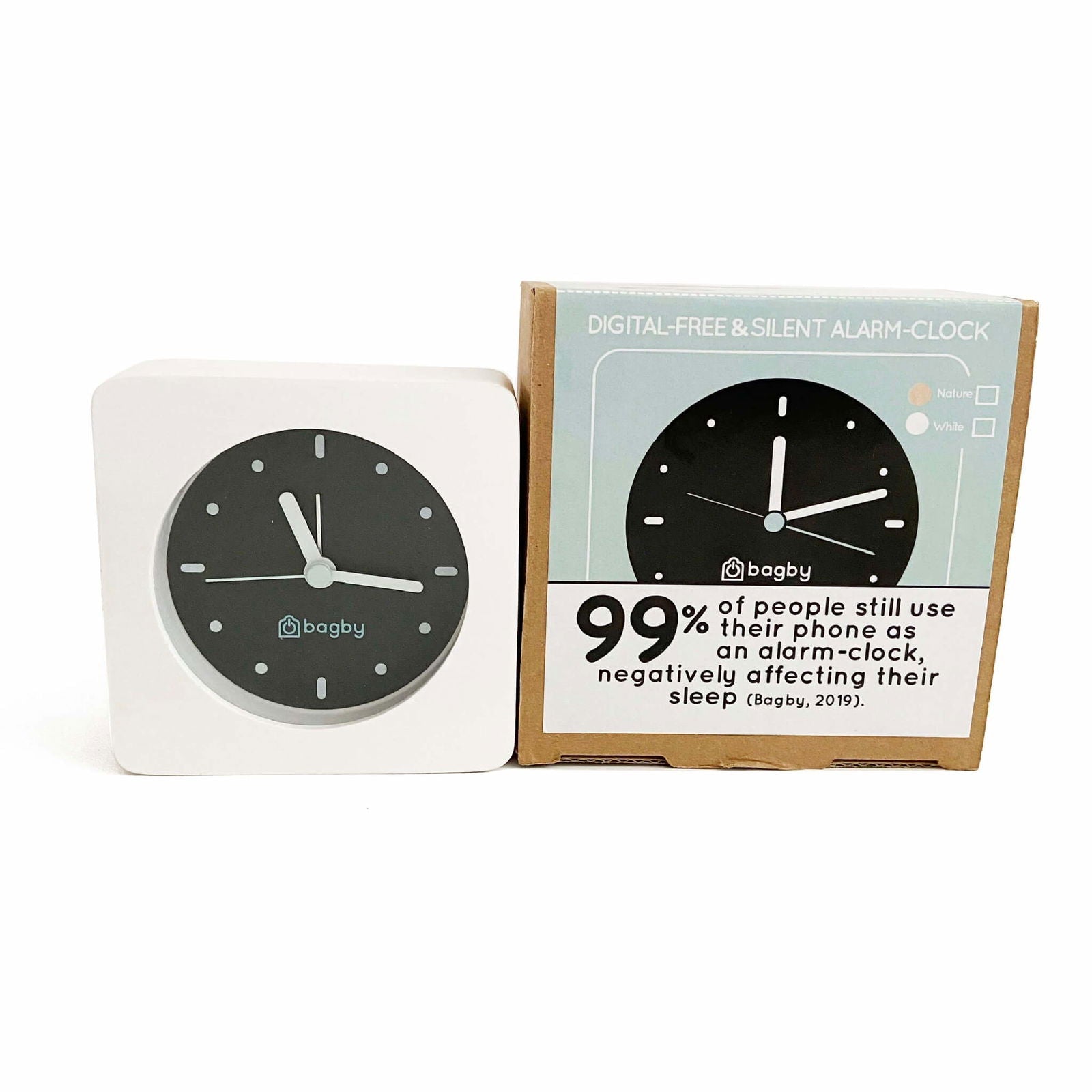 Bagby Minimalist analog alarm clock with solid wood frame and number-free dial on a nightstand