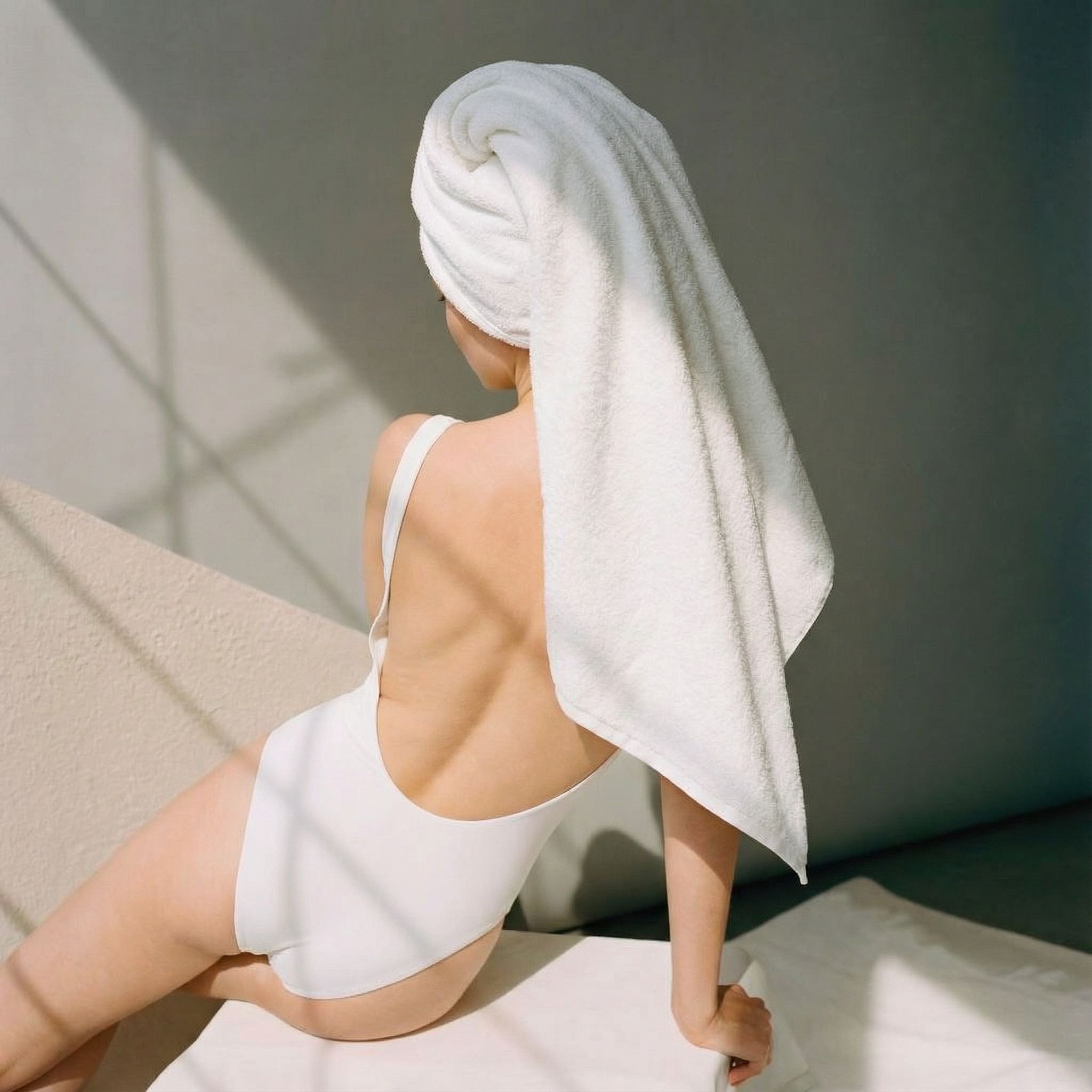 Stack of folded thick white 800 GSM Australian cotton bath towels showing dense plush loop texture