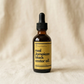Yaga Lifestyle Jamaican Black Castor Oil bottle on wooden background