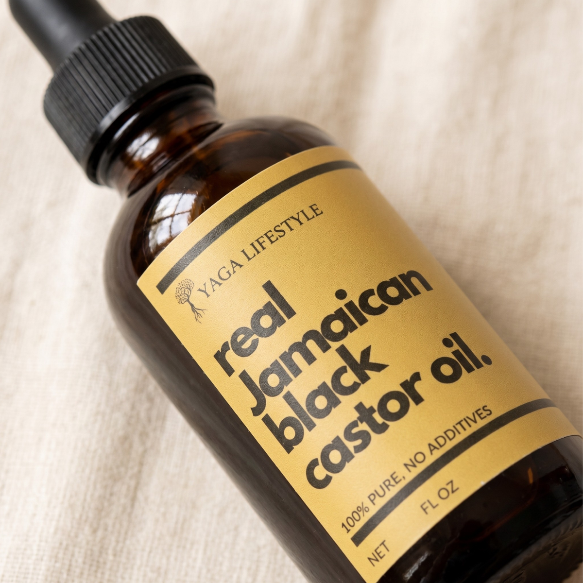 Yaga Lifestyle Jamaican Black Castor Oil bottle on wooden background