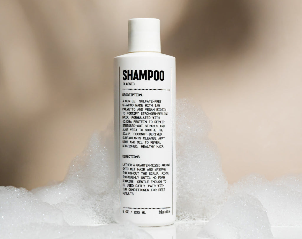 Bottle of natural daily shampoo with saw palmetto and vegan biotin on a clean surface