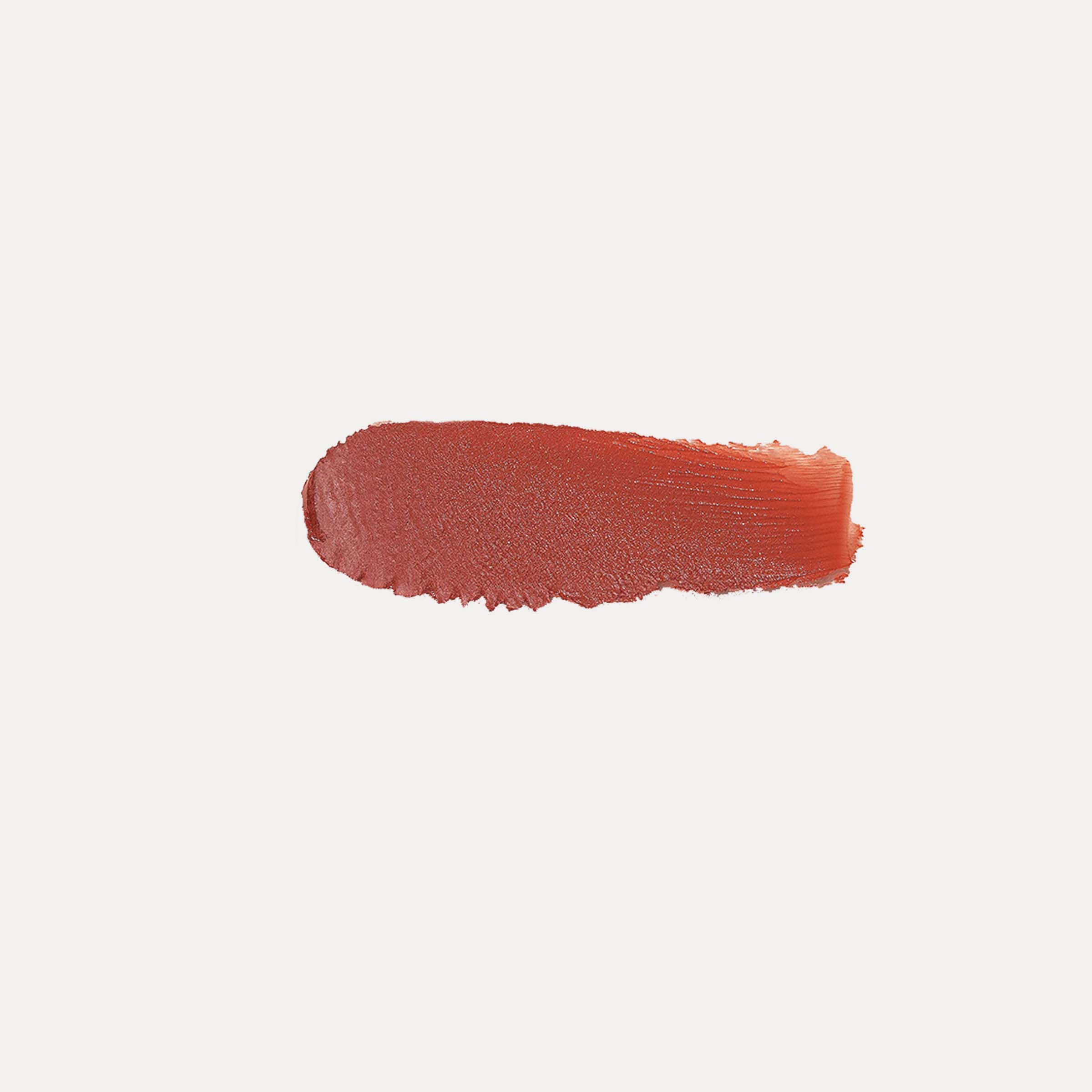 Close-up of buildable cream blush compact with a soft rosy swatch on fair skin showing a dewy, natural flush